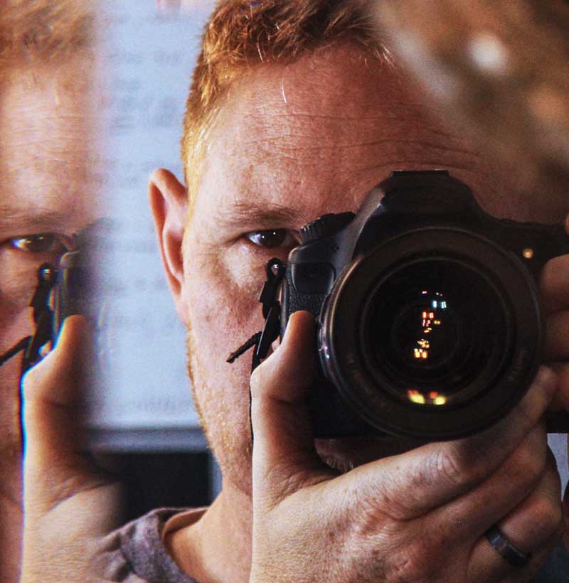Self portrait of the photographer in a mriror with grunge style and extreme lighting