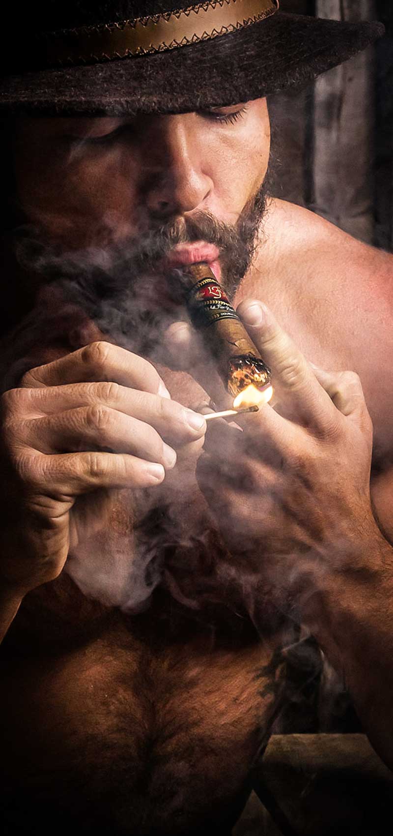 personal art photo, sexy, shirtless man smoking a cigar