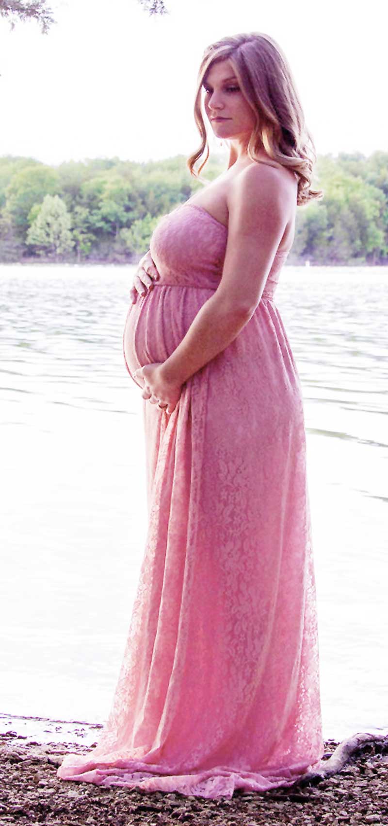 Baby bump, personal maternity pic of a curvy pregnant woman by the lake.