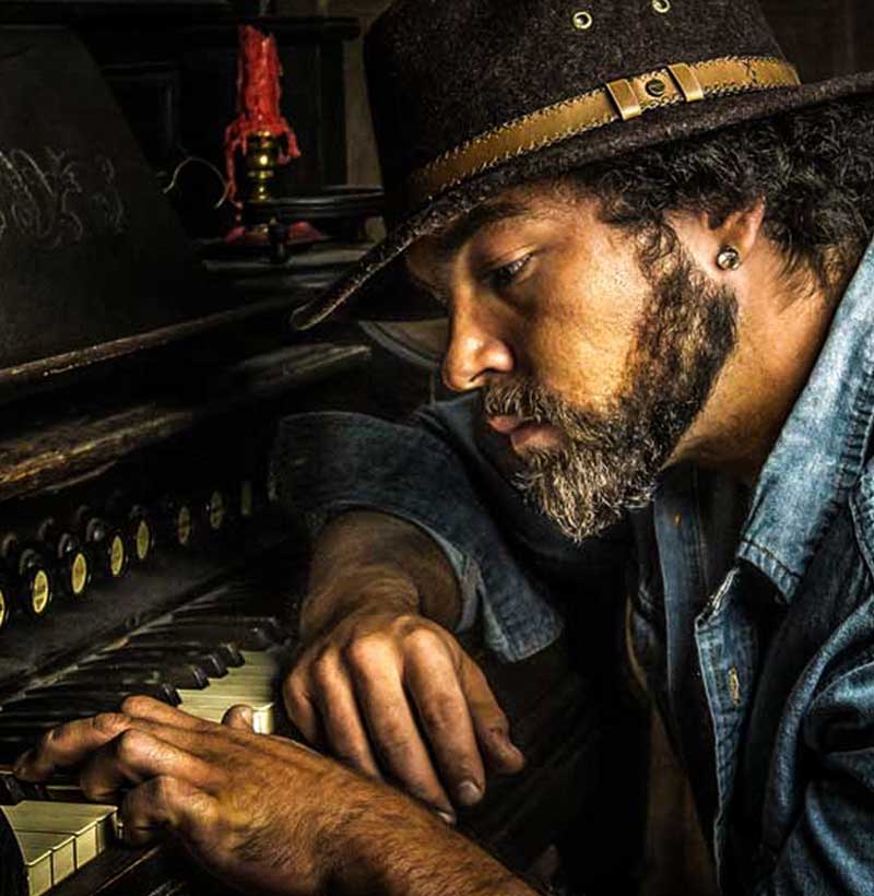 grunge style west punk portrait of a man at the keyboard